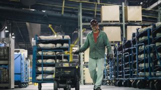Factory worker moving a pallet of product