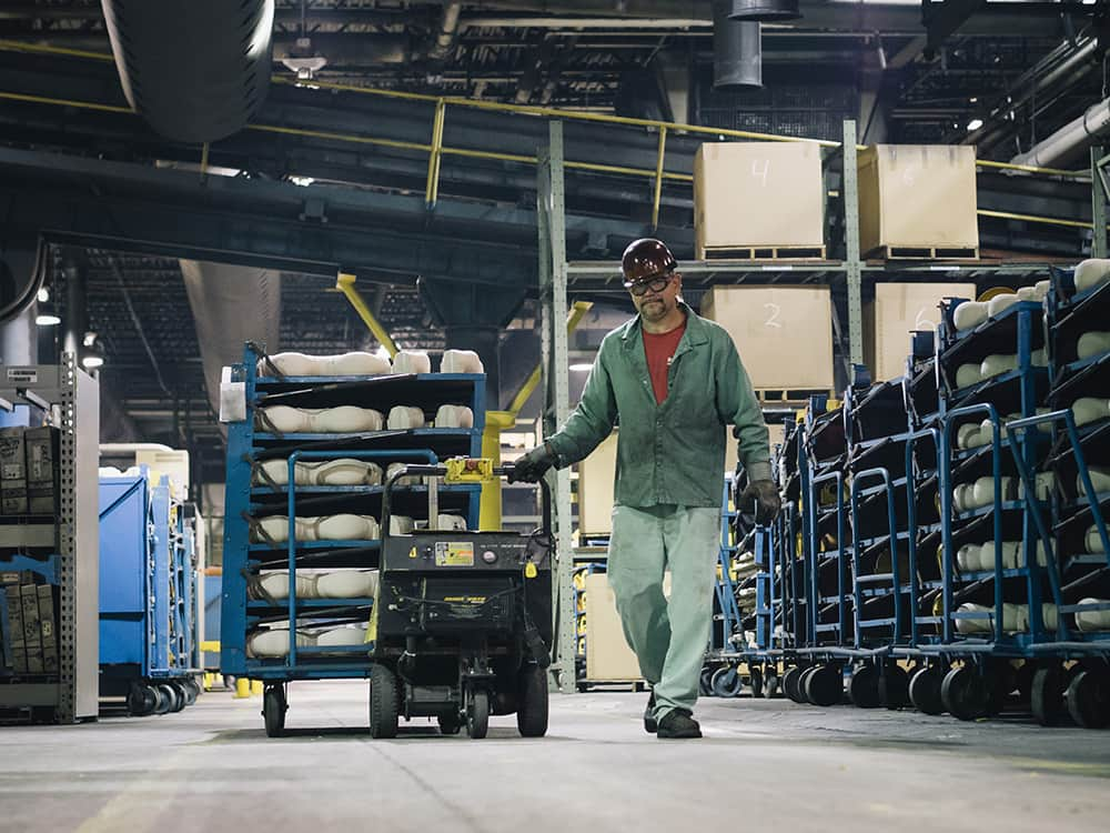 Factory worker moving a pallet of product