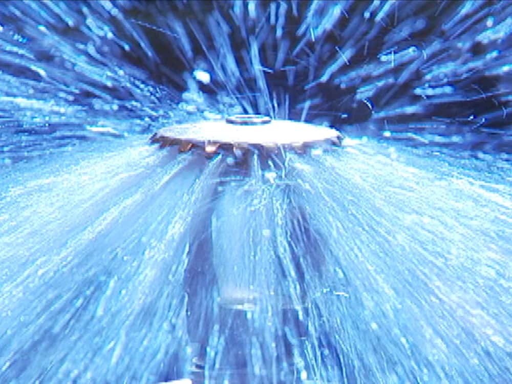 Close-up of fire sprinkler head discharging water
