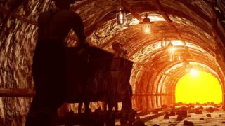 Worker pushing the cart in the mine.