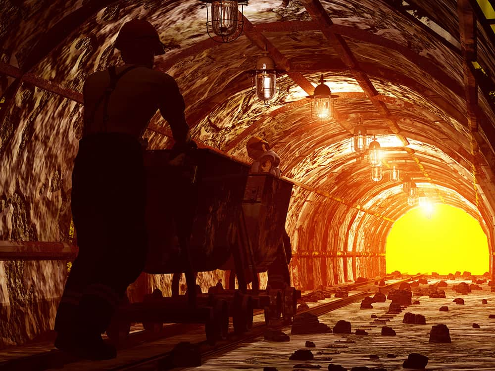 Worker pushing the cart in the mine.