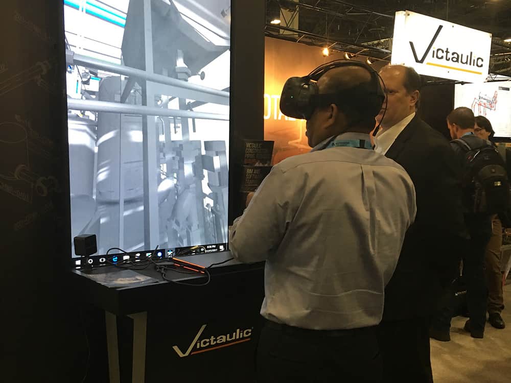 Two men demoing Victaulic virtual reality BIM software at Autodesk University in 2017