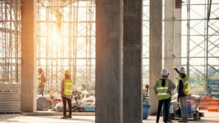 Construction engineers supervising progress of construction project