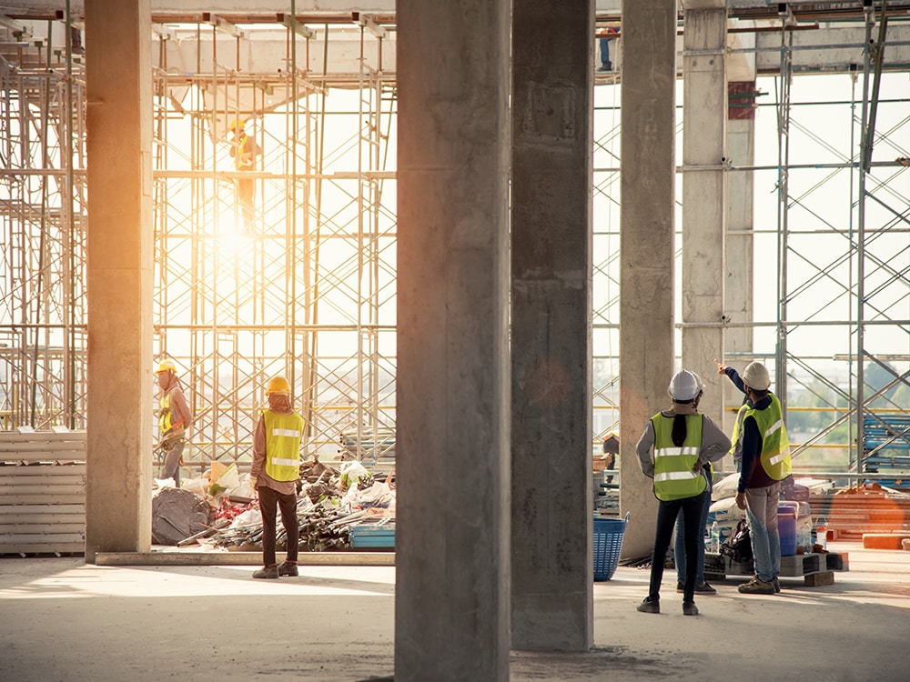 Construction engineers supervising progress of construction project