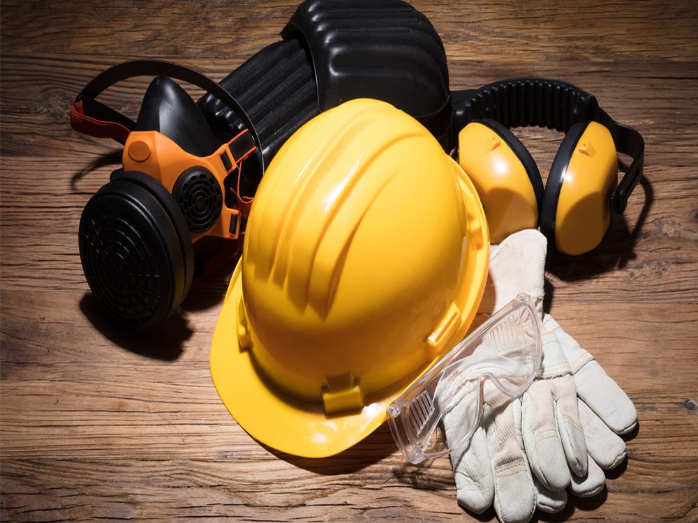 yellow hardhat & other safety wear representing mining covid safety protocals