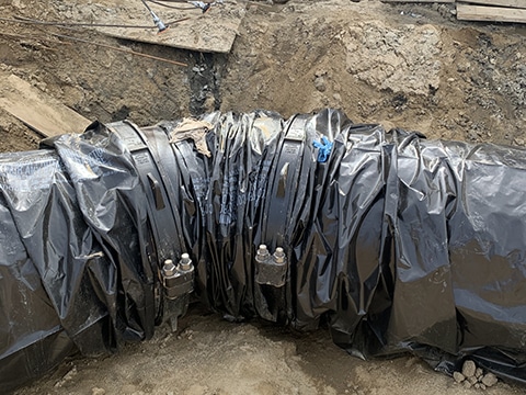 Covered ductile iron pipe