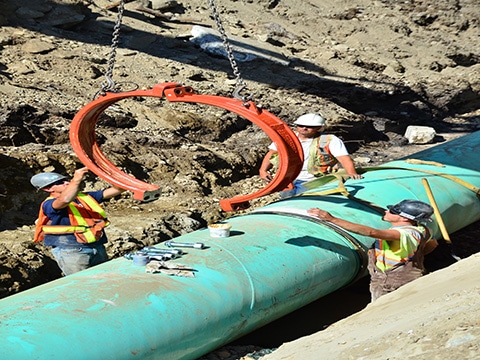 AGS coupling housing being lowered toward the pipeline