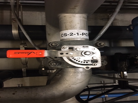 Close up of Series 461 Butterfly Valve and Stainless Steel couplings joined to pipe