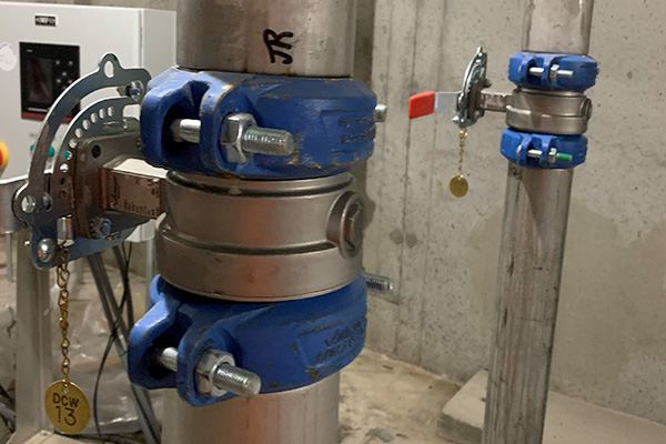 Series 861 Butterfly Valve joined in between two Series 877 Couplings on Stainless Steel piping